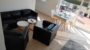 a living room with a couch and a table and chairs at Ferienwohnung Schreiber in Hessisch Oldendorf