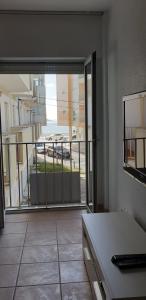 a room with an open door to a balcony at Casinhas da Praia in São Martinho do Porto