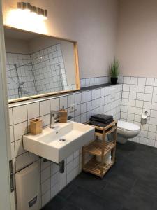 a bathroom with a sink and a toilet at Ferienwohnung Kirschholz in Schmelz