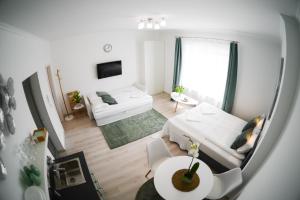 A bed or beds in a room at Rába Apartman House