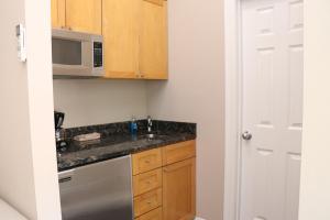 a kitchen with a sink and a microwave at Heart of South End, Convenient, Comfy Studio #22 in Boston