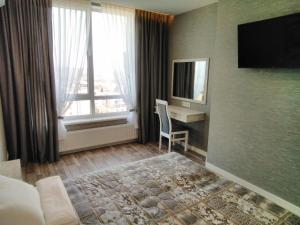 a hotel room with a bed and a window at Panorama Lviv in Lviv