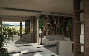 a living room with a couch and a book shelf at Iris Hotel in Siviri