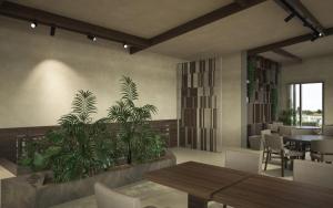 a dining room with tables and chairs and plants at Iris Hotel in Siviri