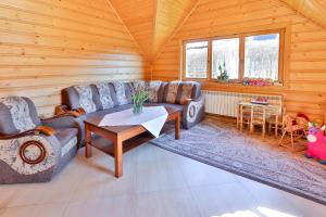 a living room with a couch and a table at Kwatery Prywatne Beata Marek in Białka Tatrzańska