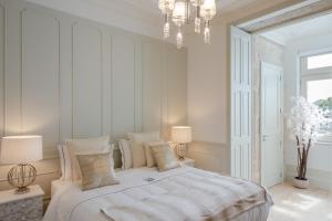 a bedroom with a large bed and a large window at Porto Deluxe Apartments in Porto