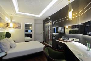 a hotel room with two beds and a television at Hotel Niles Istanbul in Istanbul
