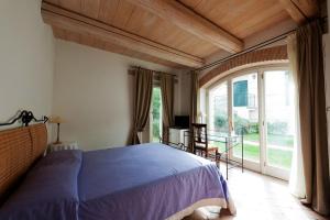 a bedroom with a bed and a large window at Valcastagno Relais in Sirolo
