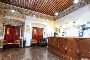 a bar in a room with a counter and chairs at La Casona de Don Lucas in Guanajuato