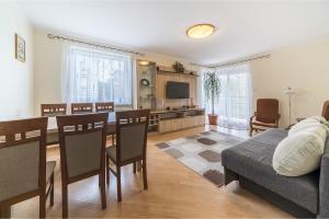 a living room with a table and a dining room at Apartament Litoral Jurata in Jurata