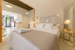 a bedroom with a large white bed with white pillows at Casa en Plaza de la Merced_Centro Flamenco_Cádiz in Cádiz