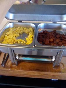 two trays of food sitting on top of a microwave at QUINZE HOTEL & POUSADA in Bataguaçu