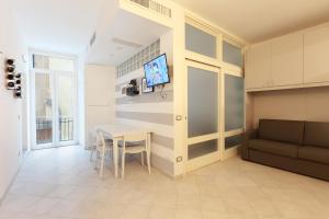 a kitchen and dining room with a table and a tv at MARGOT AL MARE in Monterosso al Mare