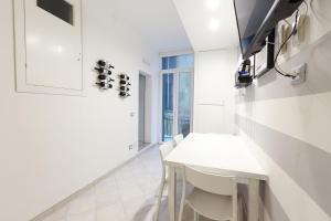 a white dining room with a white table and chairs at MARGOT AL MARE in Monterosso al Mare