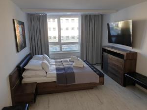 Posteľ alebo postele v izbe v ubytovaní Apartmány Urban
