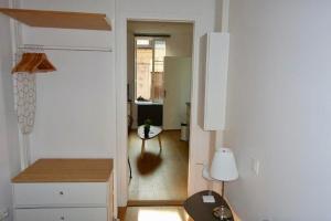a living room with a table and a hallway at Appartement Trouville s/mer Plage in Trouville-sur-Mer