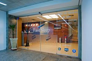 a store front with a glass door and a window at FAST SLEEP Guarulhos by Slaviero Hotéis in Guarulhos