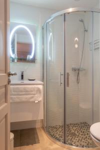 a bathroom with a glass shower and a sink at Villa Zola Apartment, the magic of the French Riviera in Le Bar-sur-Loup