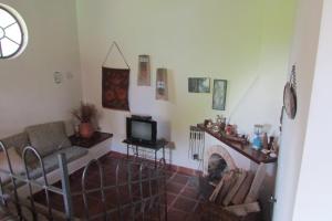 a living room with a couch and a fireplace at Sitio Prainha in Guararema