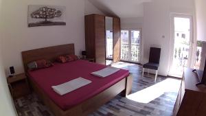 a bedroom with a large purple bed in a room at House Srima-Vodice Dalmatia in Srima