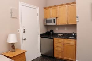 a small kitchen with a sink and a microwave at Stylish Downtown Studio in the SouthEnd, C.Ave #24 in Boston