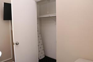 a closet with a white door and a shower at Stylish Downtown Studio in the SouthEnd, C.Ave #24 in Boston +9 photos