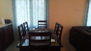 a dining room with a table and chairs and a couch at Wilks Villa in Knowles