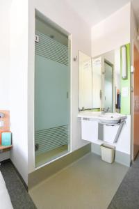 A bathroom at ibis budget Torun