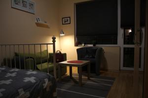 a bedroom with a bed and a table and a chair at Apartment 132 in Sofia
