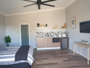a bedroom with a bed and a ceiling fan at River Retreats Kalbarri in Kalbarri
