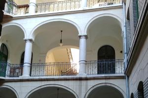 a balcony in a building with white columns at Sleepover City Center GuestRooms in Budapest