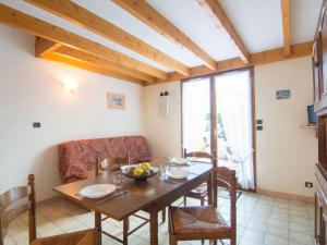 a dining room with a table and a couch at Holiday Home Jardins de l'Océan-1 by Interhome in Saint-Georges-de-Didonne