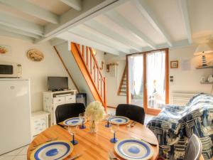 a dining room with a wooden table and chairs at Holiday Home Jardins de l'Océan-3 by Interhome in Saint-Georges-de-Didonne