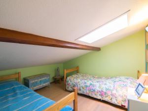 a attic bedroom with two beds and a skylight at Holiday Home Jardins de l'Océan-3 by Interhome in Saint-Georges-de-Didonne +10 photos
