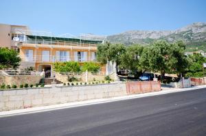a yellow house on the side of a street at Apartments Josko in Gradac