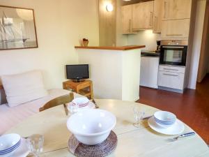 a living room with a table with a bowl on it at Holiday Home Les Palombes-3 by Interhome in Lacanau-Océan