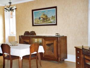 a dining room with a table and a painting on the wall at Holiday Home Villa du Lac by Interhome in Beaune