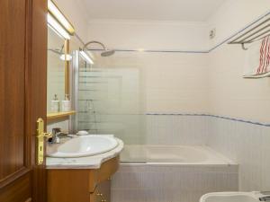 a bathroom with a sink and a bath tub at Apartment T2 Olhão by Interhome in Olhão +13 photos