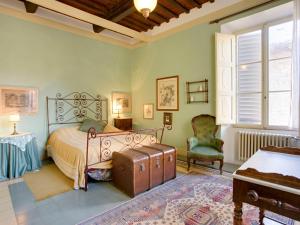 una camera con un letto con una valigia di Apartment San Girolamo by Interhome a San Gimignano