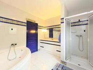 a bathroom with a tub and a shower and a sink at Holiday Home Isla Bonita by Interhome in Moraira