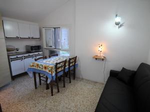 a small kitchen with a table and chairs in a room at Apartment Taverna Il Cippo by Interhome in Mortola Superiore