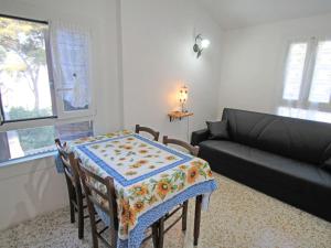 a living room with a table and a couch at Apartment Taverna Il Cippo by Interhome in Mortola Superiore