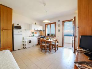 a kitchen with a table and a dining room at Apartment Salita Bellavista by Interhome in Cavo
