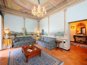 a living room with a couch and a chandelier at Villa Paolotti by Interhome in Bettona
