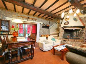 a living room with a table and a fireplace at Holiday Home Il Casale by Interhome in Lama