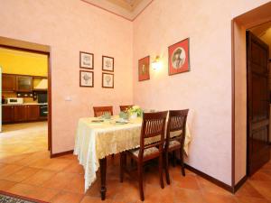 a dining room with a table and chairs and a kitchen at Villa Paolotti by Interhome in Bettona