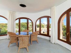 a dining room with a table and chairs and windows at Holiday Home Balcon al Mar by Interhome in Balcon del Mar
