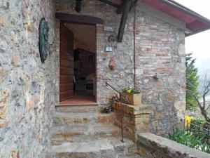a stone building with a door and a potted plant at Holiday Home Il Casale by Interhome in Lama