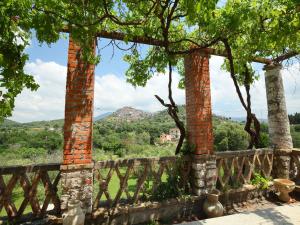 a fence with two brick columns and a view at Locazione Turistica Torretta Serviana in Montecelio