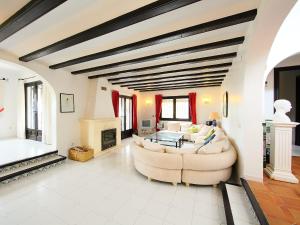 a living room with a couch and a fireplace at Holiday Home Isla Bonita by Interhome in Moraira